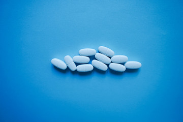 Wall Mural - White pills  on a paper background with a free area for text