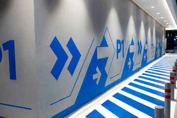 P1 Written wall with arrows in a car park of a shopping mall.