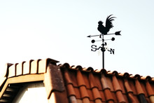 Low Angle View Of Weather Vane On Roof Against Clear Sky