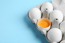 Fresh Chicken Eggs In Box On Light Blue Background, Closeup. Space For Text