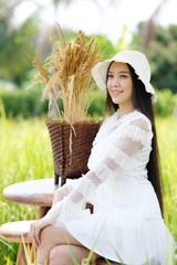 Wall Mural - portrait of a beautiful young woman in a white dress on rice field