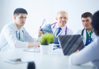 Medical team sitting and discussing at table