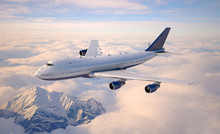 Passenger Aircraft Flying Above The Clouds.