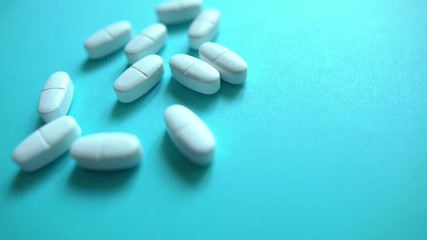 Wall Mural - White pills  on a blue background