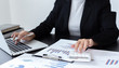 © Puwasit Inyavileart - Accounting businessmen are calculating income-expenditure and analyzing real estate investment data, Financial and tax systems concept.