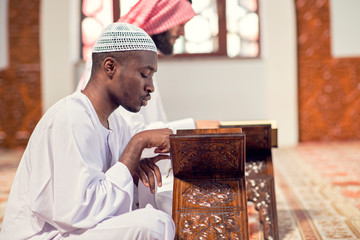 Poster - Two religious muslim man praying together inside the mosque