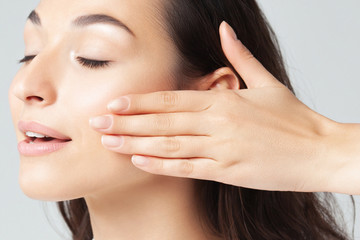 Portrait of young beautiful woman with clean perfect skin