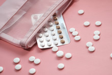 Birth Control Pills On Pink Background, Close Up 