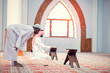 © FS-Stock - Two religious muslim man praying together inside the mosque