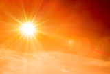 Fototapeta Krajobraz - Orange sky with bright sun symbolizing climate change and global warming