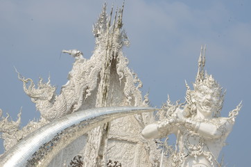 Wall Mural - An angry demon is guarding the entrance of Wat Rong Khun, the beautiful white temple in Chiang Rai