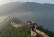 © Liudmila Puchinskaia - Great wall of China at sunny day. Amazing view of Great Wall at good weather. Mountain view in China with fog. Ancient historical wall near the beautiful landscape. Chinese people. Tourism in China.