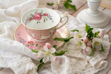 Pretty Pink Vintage Afternoon Tea Party, Tea Cup And Tender Flowers On Wooden Tray And Lace Tablecloth