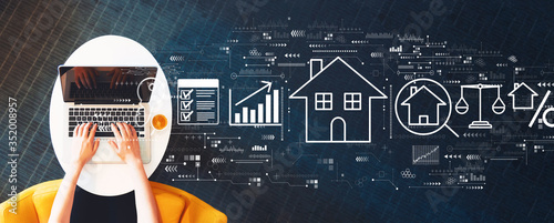 Cuadros en Lienzo Real estate theme with person using a laptop on a white table