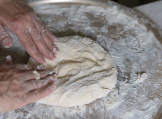 Wall Mural - Hands knead the dough for further baking