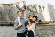 © jul14ka - A beautiful young family on the sandy shore of the ocean relaxing and have a fun