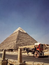 Horse Carriage At Pyramids Of Giza Against Sky