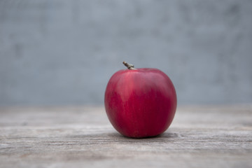 red apple on wooden table