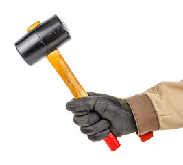 Wall Mural - Black rubber hammer with wooden handle in worker hand in black protective glove and brown uniform isolated on white background