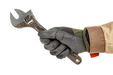 Wall Mural - Worker hand in black protective glove and brown uniform holds large old adjustable wrench isolated on white background