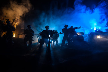 War Concept. Battle scene on war fog sky background, Fighting silhouettes Below Cloudy Skyline at night.