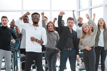 Wall Mural - group of happy young people standing with their hands up