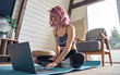 © insta_photos - Young fit sporty teen hipster girl pink hair wear sportswear search online fitness yoga class using laptop computer sit at home. Online fitness workout video tutorial virtual coach teacher concept.