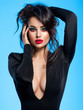 © Valua Vitaly - Portrait of beautiful young woman with bright blue makeup.  Pretty girl with long black hair. Brunette woman in a black clothes. Sexy girl. Beautiful brunette with bright red lipstick on her lips..