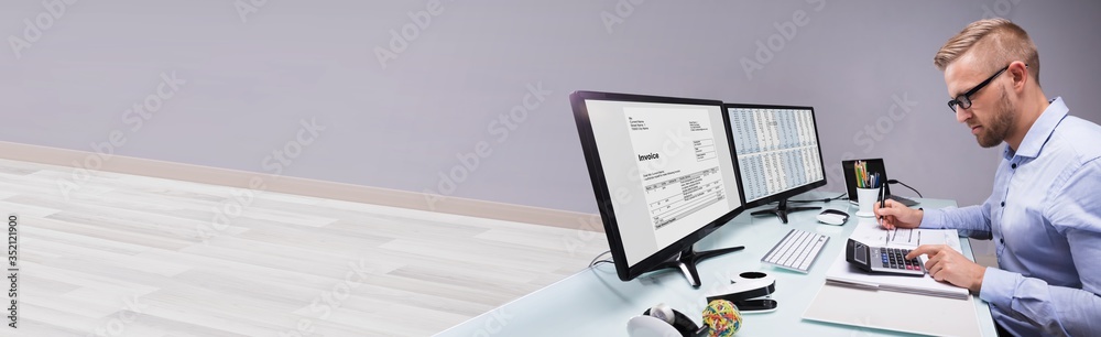 Side View Of A Businessman Calculating Invoice - obrazy, fototapety, plakaty 