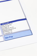 Wage pay slip showing pension, national insurance and tax earnings deductions.  Isolated on a white background