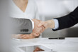 © rogerphoto - Business people shaking hands finishing contract signing, close-up. Business communication concept. Handshake and marketing