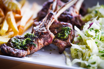 Wall Mural - delicious grilled lamb chopsticks with french fries, pesto sauce & mix of lettuces