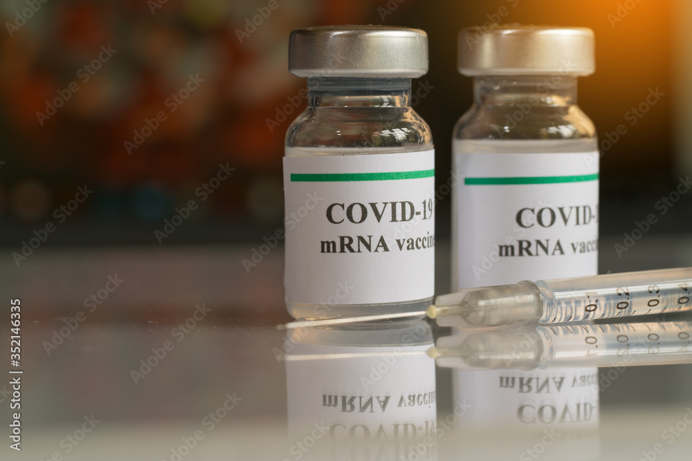 COVID-19 mRNA Vaccine and syringe with needle injection. It use for ...