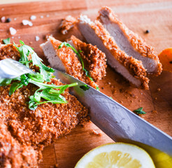 Wall Mural - delicious crispy panko pork schnitzel with wedges & fresh pepper