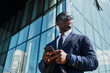 © sata_production - African businessman with smart phone outdoor