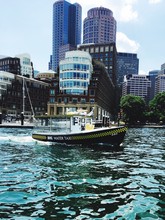 Water Taxi At Boston Harbor Against Buildings