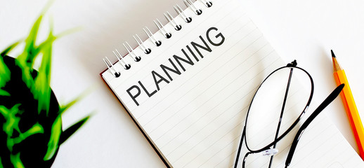 Poster - Notebook with glasses and pencil on white background, business concept Planning