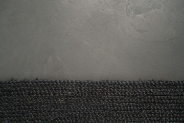 Wall Mural - black jute floor rag border on concrete floor