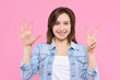 © Monstar Studio - Cheerful smiling girl dressed in white t-shirt, denim jacket on pink background. Young woman is showing with fingers number seven, percents, discount. Female gesturing. Emotional portrait concept.