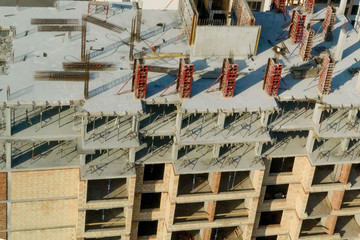 Construction and construction of high-rise buildings, the construction industry with working equipment and workers. View from above, from above. Background and texture