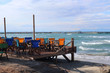 Colorful beach chairs and tables on the beach. Peraia beach, suburb of Thessaloniki, Greece.