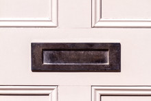 Polished Steel Letterbox On  Whit Wooden Front Door