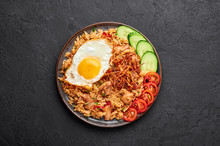 Nasi Goreng - Indonesian Chicken Fried Rice On Black Plate On Dark Slate Backdrop. Nasi Goreng Is An Indonesian Cuisine Dish. Balinese Food. Asian Meal. Top View