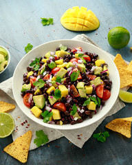 Wall Mural - Avocado, mango salad with black bean, tomato, red onion and tortilla chips. healthy food