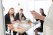 © jokekung - close up hand, hand holding laser pen and  point to information board, presenter and team discuss about strategy plan and knowledge sharing