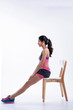 © Watcharin - Young beautiful lady wearing sportwear.Sittling on wooden chair,prepare for exercise,with happy feeling