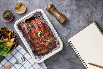 Wall Mural - Grilled pork ribs with Vegetables and sauces on a drak table