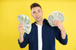 © New Africa - Emotional man with cash money on yellow background