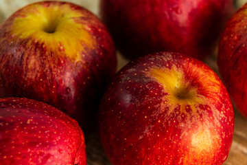 ripe red apples, wooden background