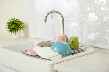 Sticker - Drying rack with clean dishes over sink in kitchen